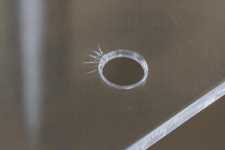 Stress crack running from a hole to the edge of an acrylic sheet