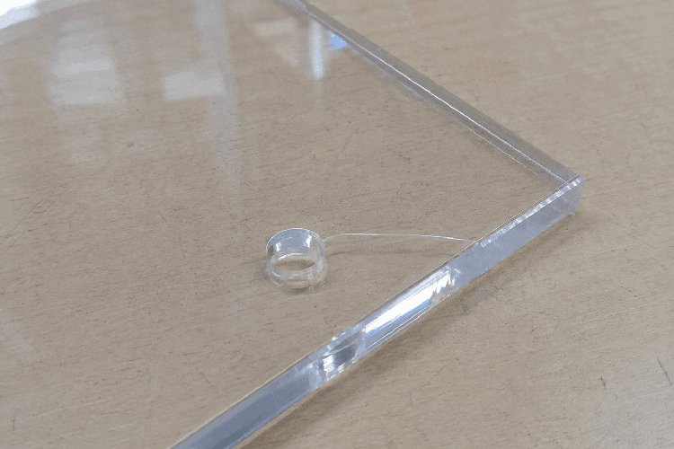 Crack running from an undersized hole to the edge of an acrylic sheet