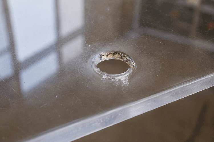 Melted hole edge caused by excessive heat generation