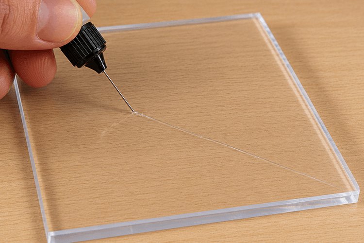 Repairing a small crack in acrylic glass with a fine dispensing tip