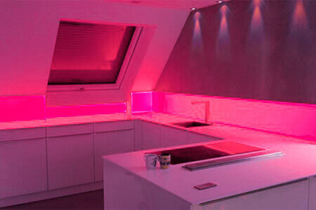 A kitchen unit with acrylic spigot protection with red backlighting